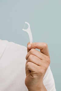 Man holding a dental floss