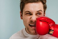 Man  getting hit with a red boxing glove