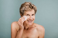 woman wiping her face with a cotton pad