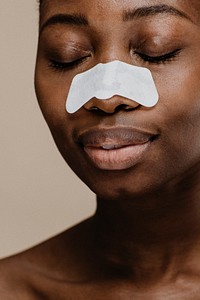 Black woman with a nose pore strip