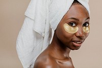 Black woman wearing a golden eye mask