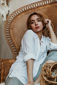 Woman relaxing on a vintage wicker chair