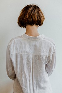 Rear view of a short dyed hair in a white shirt