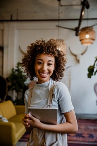 Cheerful woman holding a digital tablet in her arm