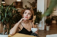 Woman having a coffee in her living room