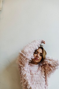 Portrait of a cheerful woman in a light pink sweater