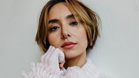 Portrait of a cheerful woman in a light pink sweater