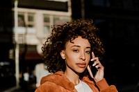 Black woman making a call in downtown