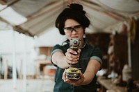 Female carpenter with a hand drill