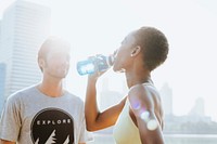 Fitness couple drinking water after workout