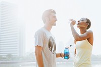 Fitness couple drinking water after workout