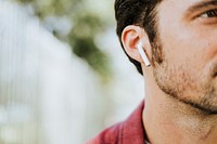 Man listening to music by a wireless earphones