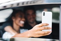 Happy and loving couple taking a selfie in a car