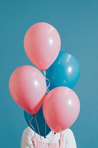 Woman with pink and blue balloons