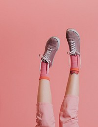 Woman legs in pink pants up in the air