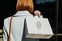 Woman with a shopping bag after a spending spree
