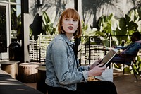 Woman using a digital tablet in a cafe