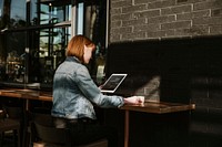 Woman using a digital tablet in a cafe