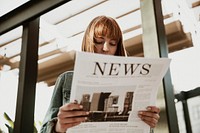 Woman reading a newspaper in a cafe