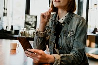 Woman using her phone in a cafe