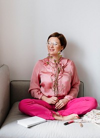 Cheerful woman in a pink shirt holding waxflowers