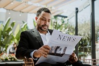 Businessman reading a newspaper in a cafe