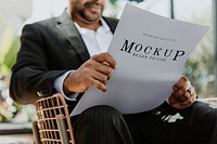 Businessman reading a newspaper in a cafe