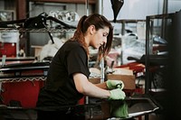 Female mechanic pulling out the weather seal of a vehicle