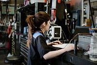 Female mechanic analysing the report