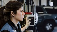 Female mechanic holding a switch in the garage