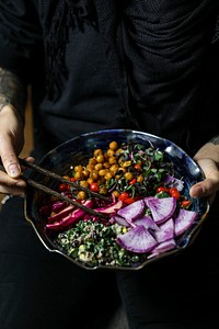 Woman having organic buddha bowl for lunch