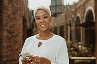 Happy black woman using her smartphone