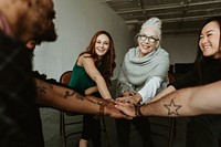 Group of diverse team joining hand in the middle