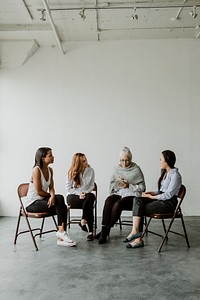 Diverse women in a  supporting group session