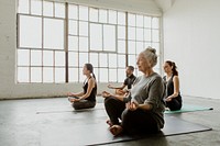 Diverse people meditating in a yoga class