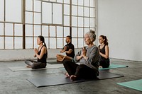 Diverse people meditating in a yoga class