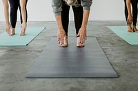 Sporty people practicing Uttanasana pose