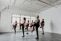 Diverse people stretching their knees in a yoga class