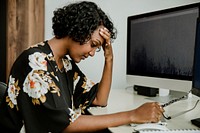 Stressed black businesswoman working in the office