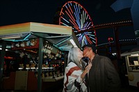 Cheerful elderly couple kissing at Pacific Park in Santa Monica, California