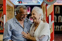 Cheerful senior couple at a game arcade