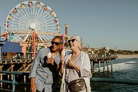 Smiling senior couple having ice cream at Santa Monica Pier