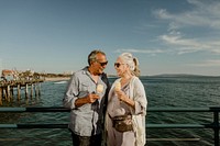Smiling senior couple with an ice cream cone standing on the Santa Monica Pier
