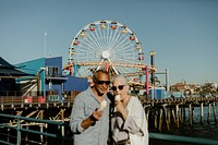 Smiling senior couple having ice cream at Santa Monica Pier
