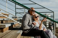 Romantic senior couple sitting on the pier