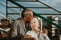 Romantic senior couple sitting on the pier