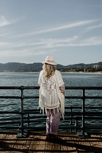 Senior woman standing the by the pier