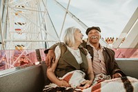 Cheerful senior couple enjoying a Ferris wheel by the Santa Monica pier