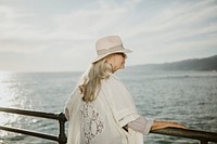 Senior woman standing by the pier