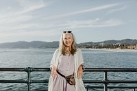 Happy senior woman standing on the pier